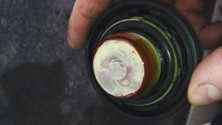 milky white substance on oil cap