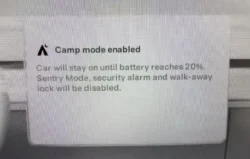 Tesla in Camp Mode, maintaining climate control and other functions, with a notification indicating battery conservation at 20%.