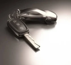 Key car and key ring over the metallic table. Clipping path included.